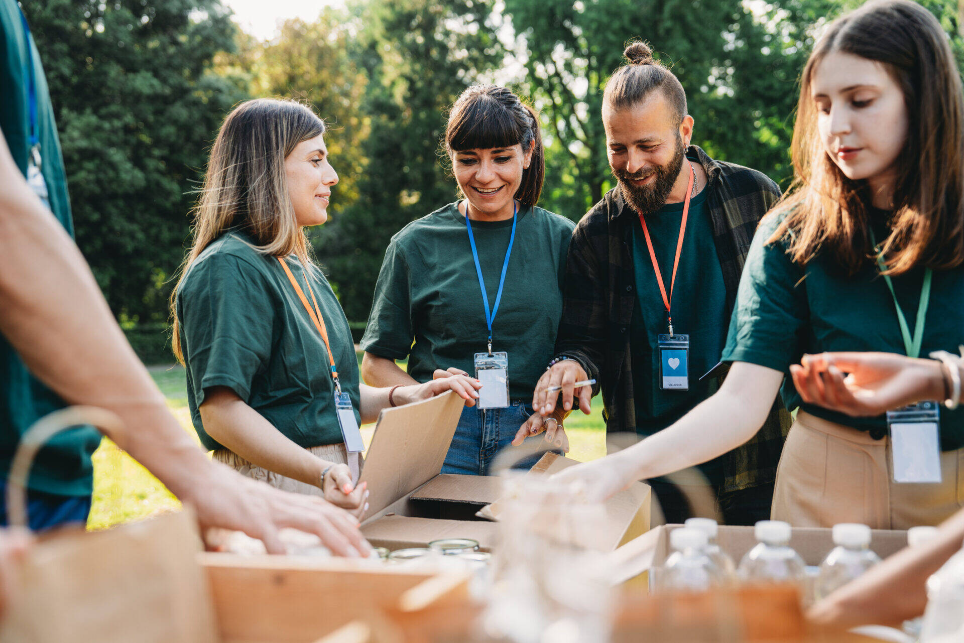 Volunteers are preparing donation boxes at the food and clothes bank. Humanitarian aid project concept.