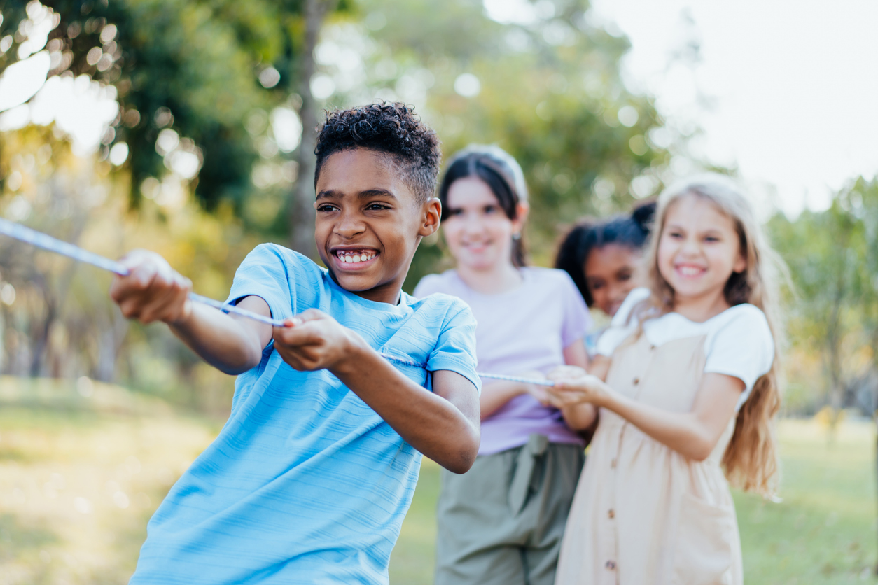 Group of children playing tug of war
